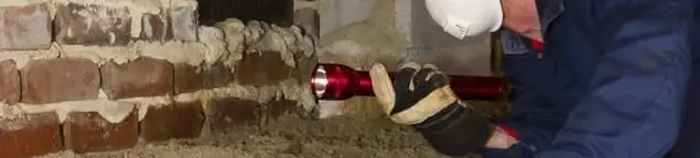 Pest control technician inspecting a crawl space for ant activity and entry points in Cincinnati, OH