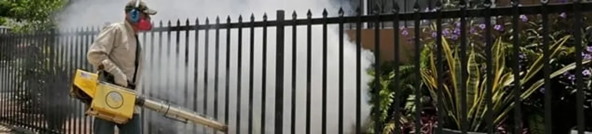 Mosquito control technician fogging a yard perimeter for mosquito reduction in Cincinnati, OH